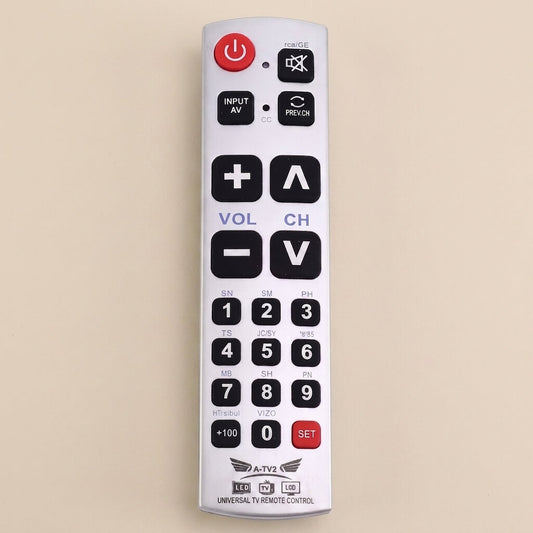 White big-button universal TV remote standing upright on a soft cream studio background, showing the large power, volume, channel and number keys.