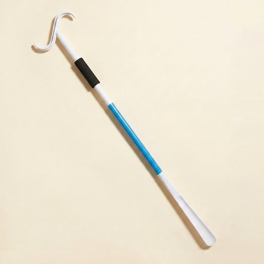 Telescopic dressing stick on a cream studio background, showing the dressing hook, foam grip and blue telescoping shaft with shoehorn end
