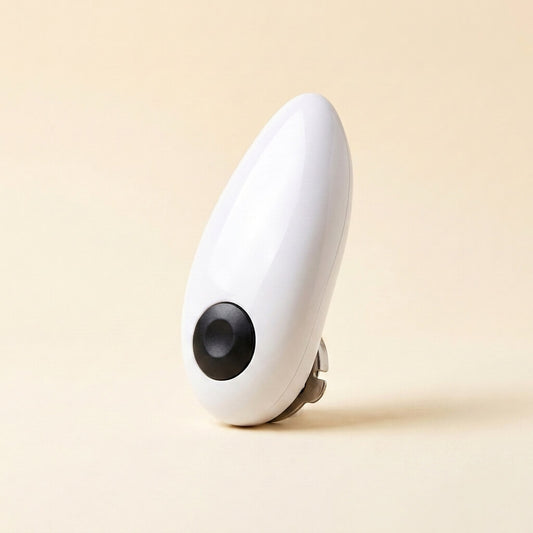White electric jar opener standing upright on a cream studio background, showing the one-touch button and gripping teeth underneath