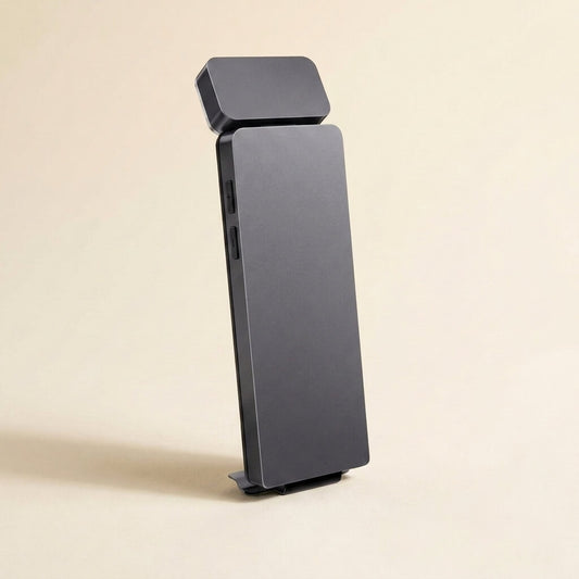 Slim bookmark-style clip-on reading light standing upright on a soft cream studio background