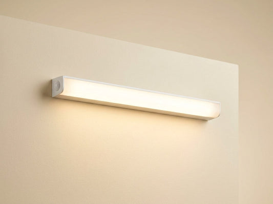 Motion-Sensing Pathway Light glowing warm white on a dark hallway wall